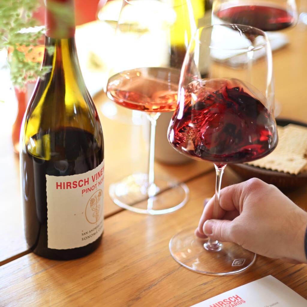 Tasting Pinot Noir from Hirsch Vineyards swirling wine glass.